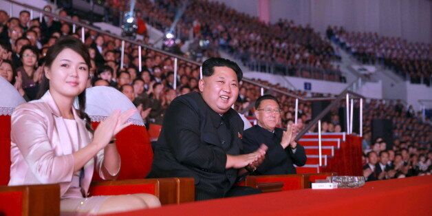 North Korean leader Kim Jong Un (2nd L) and wife Ri Sol Ju (L) enjoy a joint performance given by the State Merited Chorus and the Moranbong Band celebrating the 70th founding anniversary of the Workers' Party of Korea in this undated photo released by North Korea's Korean Central News Agency (KCNA) in Pyongyang on October 19, 2015. REUTERS/KCNA ATTENTION EDITORS - THIS PICTURE WAS PROVIDED BY A THIRD PARTY. REUTERS IS UNABLE TO INDEPENDENTLY VERIFY THE AUTHENTICITY, CONTENT, LOCATION OR DATE OF THIS IMAGE. FOR EDITORIAL USE ONLY. NOT FOR SALE FOR MARKETING OR ADVERTISING CAMPAIGNS. NO THIRD PARTY SALES. THIS PICTURE IS DISTRIBUTED EXACTLY AS RECEIVED BY REUTERS, AS A SERVICE TO CLIENTS. SOUTH KOREA OUT. NO COMMERCIAL OR EDITORIAL SALES IN SOUTH KOREA.