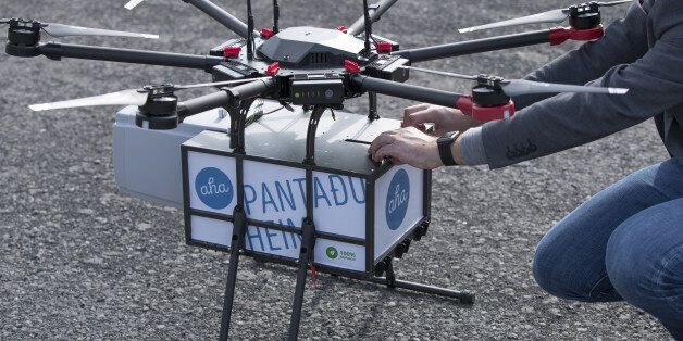 Maron Kristofersson, chief executive officer of Aha, handles a package secured to a drone manufactured by Flytrex in ReykjavÃk, Iceland, on Friday, Aug. 25, 2017. Flytrexs drones will fly more than 2.5 kilometers (1.6 mile) across a large bay that separates two parts of the city, delivering for online marketplace Aha. Photographer: Arnaldur Halldorsson/Bloomberg via Getty Images