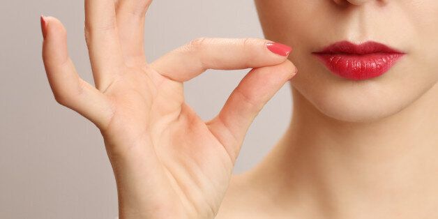 Woman zipping her mouth shut - keeping quiet concept