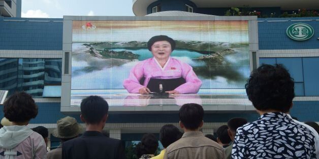 TOPSHOT - Residents watch a big video screen on Mirae Scientists Street in Pyongyang showing newsreader Ri Chun-Hee as she announces the news that the country has successfully tested a hydrogen bomb on September 3, 2017.North Korea declared itself a thermonuclear power on September 3, after carrying out a sixth nuclear test more powerful than any it has previously detonated, presenting President Donald Trump with a potent challenge. / AFP PHOTO / KIM Won-Jin (Photo credit should read KIM WON-JIN/AFP/Getty Images)