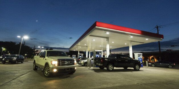 Customers wait to refuel at an Exxon Mobil Corp. gas station at dusk in Houston, Texas, U.S., on Thursday, Aug. 24, 2017. Hurricane Harvey, set to make landfall on the center of the Texas coast late Friday, is expected to hit a refinery-rich stretch of the Gulf Coast and U.S. drivers could soon see the impact at the gas pump. Photographer: F. Carter Smith/Bloomberg via Getty Images