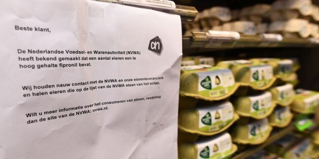This photo taken on August 8, 2017 in Alkmaar shows a warning letter reading 'The Dutch agency for food security (NVWA) has announced that some eggs contain too high fipronil content. Keep close contact with the NVWA and our egg suppliers and pick up eggs listed by the NVWA list of the shelf. If you want more information about consuming eggs, please consult the NVWA site,' next to eggs for sale at supermarket.Several European countries face a growing scare over millions of eggs that have been co