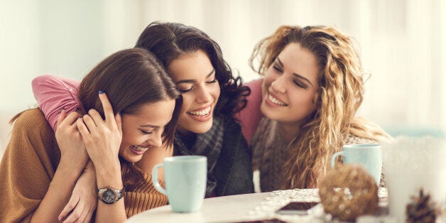 Three happy women enjoying at home and embracing.