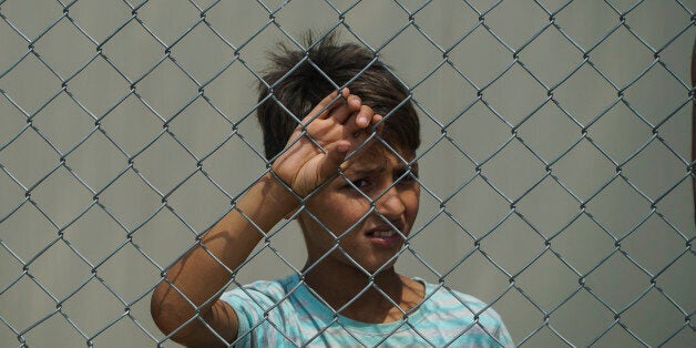 Refugees are protesting in Diavata Camp (Former Anagnostopoulou military camp), in Thessaloniki, Greece, on August 17, 2017. They blocked the entrance and rushed out all the government and ngo employees including army and police. Refugees and migrants are from Syria, Iran, Afghanistan, Pakistan and Kurdish in this camp. They are protesting because in the transformed house containers that they live, more people will come. The camp hosts about 350 people with AC, kitchen, WC in each container and the number of the guests can be expanded at least for more 20%. The government is bringing , actually relocation from camps in bad conditions from the islands, 27 people by bus to this camp. Each container house can host 6 people. For the moment in most of the houses live 4 people. Refugees even denied to reunite their families that hold two containers. The ministry arranged a few empty containers but refugees and migrants still keep protesting. Other demands from the refugees are to leave the camp and live in house, relocate to European countries like Germany and organize a school in the camp for little children. Local authorities and police are blocked outside of the camp. The temperature in the camp is about 36Â°C right now and they still stay outside. (Photo by Nicolas Economou/NurPhoto via Getty Images)