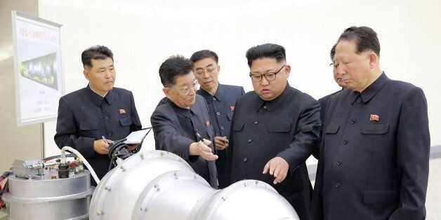 This undated picture released by North Korea's official Korean Central News Agency (KCNA) on September 3, 2017 shows North Korean leader Kim Jong-Un (C) looking at a metal casing with two bulges at an undisclosed location.North Korea has developed a hydrogen bomb which can be loaded into the country's new intercontinental ballistic missile, the official Korean Central News Agency claimed on September 3. Questions remain over whether nuclear-armed Pyongyang has successfully miniaturised its weapons, and whether it has a working H-bomb, but KCNA said that leader Kim Jong-Un had inspected such a device at the Nuclear Weapons Institute. / AFP PHOTO / KCNA VIA KNS / STR / South Korea OUT / REPUBLIC OF KOREA OUT ---EDITORS NOTE--- RESTRICTED TO EDITORIAL USE - MANDATORY CREDIT 'AFP PHOTO/KCNA VIA KNS' - NO MARKETING NO ADVERTISING CAMPAIGNS - DISTRIBUTED AS A SERVICE TO CLIENTSTHIS PICTURE WAS MADE AVAILABLE BY A THIRD PARTY. AFP CAN NOT INDEPENDENTLY VERIFY THE AUTHENTICITY, LOCATION, DATE AND CONTENT OF THIS IMAGE. THIS PHOTO IS DISTRIBUTED EXACTLY AS RECEIVED BY AFP. / (Photo credit should read STR/AFP/Getty Images)
