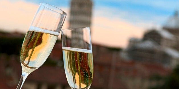 Two glasses of champagne with the Tower of Pisa in the background