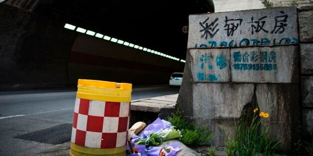 Flowers are placed at the entrance of the Taojiakuang tunnel in the city of Weihai in Shandong province on May 10, 2017.Eleven South Korean and Chinese kindergarteners and their driver were killed when a school bus crashed and burst into flames in a tunnel in eastern China on May 9, officials said. / AFP PHOTO / Johannes EISELE (Photo credit should read JOHANNES EISELE/AFP/Getty Images)