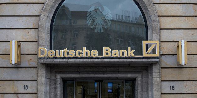 Signage for Deutsche Bank AG sits above a bank branch in Frankfurt, Germany, on Thursday, July 20, 2017. Frankfurt has emerged as a winner of the Brexit vote, with Standard Chartered Plc, Nomura Holdings Inc., Sumitomo Mitsui Financial Group Inc. and Daiwa Securities Group Inc. picking the city as their EU hub in recent weeks. Photographer: Krisztian Bocsi/Bloomberg via Getty Images