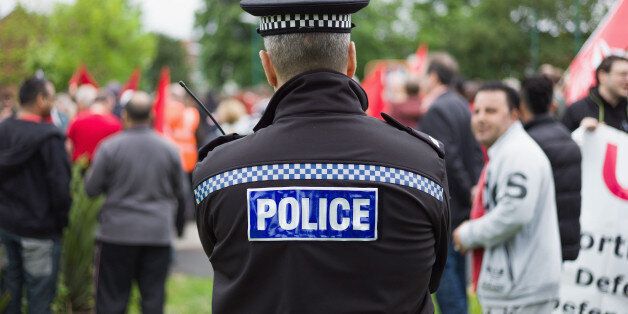 MIDDLESBROUGH, ENGLAND - JUNE 28: A police officer looks on during a demonstration aimed to celebrate diversity on Teesside and which was held to voice opposition against the English Defence League on June 28, 2014 in Middlesbrough, England. Following this demonstration an EDL demonstration was also held in the town. (Photo by Ian Forsyth/Getty Images)