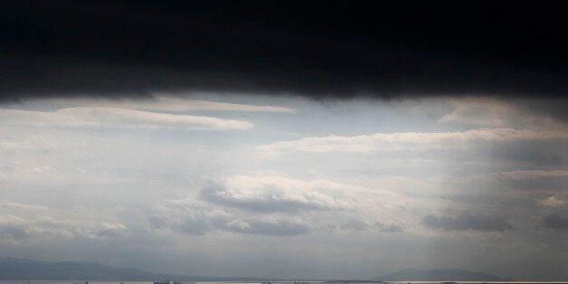 Cargo ships are seen sailing under storm clouds at open sea near the port of Piraeus, in Athens March 5, 2015. REUTERS/Alkis Konstantinidis (GREECE - Tags: ENVIRONMENT SOCIETY MARITIME TPX IMAGES OF THE DAY)