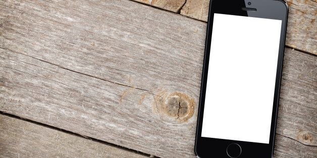 Smart phone on wooden table background with copy space
