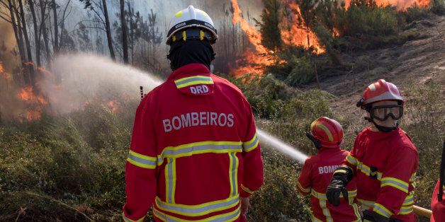 VILA DE REI, PORTUGAL - AUGUST 14: Portuguese firefighters combat flames at a forest fire on August 14, 2017 in Vila de Rei, Portugal. More than a thousand firefighters and military personnel have joined efforts trying to control the numerous fires in the country. The Portuguese government has asked for EU help to combat hundreds of forest fires in both Centro and Norte regions of the country. (Photo by Horacio Villalobos - Corbis/Corbis via Getty Images)