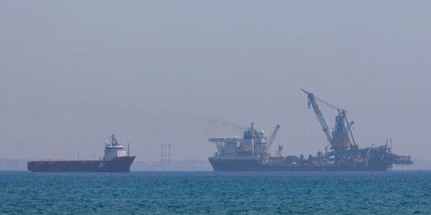 LARNACA, CYPRUS - JULY 12: The Field Development Ship Saipem FDS in Larnaca port on July 12, 2017 in Larnaca, Cyprus.Eni has awarded Saipem a contract for the drilling of two wells offshore Cyprus. Work will once again be carried out by the Saipem 12000 and commence in the fourth quarter of 2017. Saipem was founded in 1957 as a service provider for the Eni group, through the merger of Snam Montaggi and a drilling contractor SAIP. In 1960s it started providing services outside the Eni group, and in 1969 it started operating autonomously. (Photo by Athanasios Gioumpasis/Getty Images)