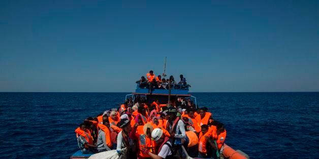 Migrants are rescued by members of the Aquarius rescue ship run by non-governmental organisations (NGO) 'SOS Mediterranee' and 'Medecins Sans Frontieres' (Doctors Without Borders) in the Mediterranean Sea, 30 nautic miles from the Libyan coast, on August 2, 2017. Italy on August 2, 2017 began enforcing a controversial code of conduct for charity boats rescuing migrants in the Mediterranean as new figures revealed a sharp drop in the numbers of people arriving from Libya. / AFP PHOTO / Angelos Tzortzinis (Photo credit should read ANGELOS TZORTZINIS/AFP/Getty Images)