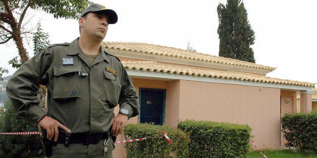 Gouvia, GREECE: A Greek policeman guards the bungalow of the Corcyra hotel where the two British children were found dead Thursday, on 28 October 2006. A carbon monoxide leak has been blamed for the death of the two British children found beside their comatose father and his female companion in the hotel bungalow on the Greek Ionian Sea island of Corfu, a coroner said on Saturday. AFP PHOTO /DIMITRA LOUVROU (Photo credit should read Dimitra Louvrou/AFP/Getty Images)