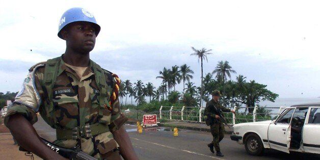 Nigerian United Nations peacekeeper guards a joint check-point with a Royal Marine Commando in Freetown May 30. The United Nations said on Tuesday it had urged Siera Leone's rebels to allow free movement to 258 peacekeepers they have surrounded in the bush for about four weeks.NSO