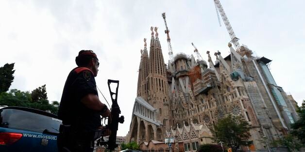 Police officers stand guard in front of the 'Sagrada Familia' (Holy Family) basilica in Barcelona on August 19, 2017, two days after a van ploughed into the crowd, killing 13 persons and injuring over 100. Drivers have ploughed on August 17, 2017 into pedestrians in two quick-succession, separate attacks in Barcelona and another popular Spanish seaside city, leaving 14 people dead and injuring more than 100 others. / AFP PHOTO / LLUIS GENE (Photo credit should read LLUIS GENE/AFP/Getty Images)