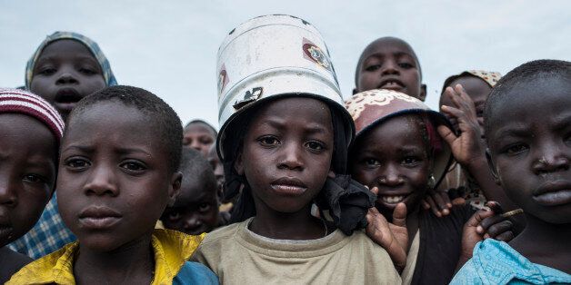 Children pose at one of the Internally-Displaced People (IDP) camps Gwoza, north-eastern Nigeria, on August 1, 2017.Boko Haram seized Gwoza in July 2014, making it the headquarters of their so-called Caliphate. Although it was retaken by Nigerian troops in March 2015, the extremists continued to raid nearby villages from their hideouts in the mountains along the border with Cameroon. At least 20,000 people have been killed and 2.6 million others displaced since the hardline Islamist group began a rebellion in 2009. / AFP PHOTO / STEFAN HEUNIS (Photo credit should read STEFAN HEUNIS/AFP/Getty Images)