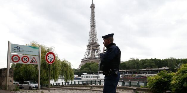 A French police officer patrols on the Seine River near the Eiffel Tower in Paris on July 13, 2017. / AFP PHOTO / GEOFFROY VAN DER HASSELT (Photo credit should read GEOFFROY VAN DER HASSELT/AFP/Getty Images)