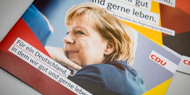 A portrait of German Chancellor and leader of Germany's conservative Christian Democratic Union party (CDU) Angela Merkel is seen on a leaflet at the CDU's headquarters in Berlin, where the party presented election campaign posters for the upcoming general elections, on August 7, 2017. / AFP PHOTO / AXEL SCHMIDT (Photo credit should read AXEL SCHMIDT/AFP/Getty Images)