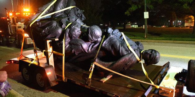 A monument dedicated to the Confederate Women of Maryland lies on a flatbed trailer near the intersection of Charles St. and University Parkway early Wednesday morning, Aug. 16, 2017 after it was taken down. (Jerry Jackson/Baltimore Sun/TNS via Getty Images)
