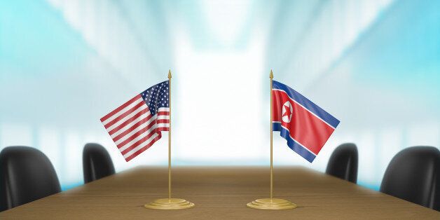 3D rendered scene of miniature flags from the United States and North Korea at a table for diplomatic negotiations.