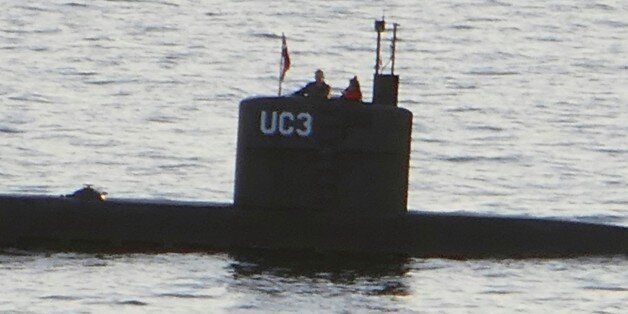 Allegedly Swedish journalist Kim Wall stands next to a man in the tower of the private submarine 'UC3 Nautilus' on August 10, 2017 in Copenhagen Harbor. Danish police said Sunday they searched a huge DIY submarine that sank last week in the hunt for the missing journalist who had been aboard before it sank, but no body was found. - / AFP PHOTO / Peter THOMPSON (Photo credit should read PETER THOMPSON/AFP/Getty Images)