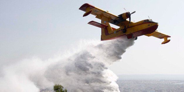 [UNVERIFIED CONTENT] GREECE,THESSALONIKI:A Canadair throws water to extinguish fire in Thessaloniki on August 26,2011