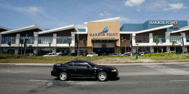 A car drives past a mall in Subic, north of Manila November 8, 2012. The Philippines, Australia and other parts of the region have seen a resurgence of U.S. warships, planes and personnel since President Barack Obama announced a