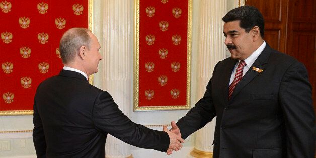 Russian President Vladimir Putin (L) shakes hands with Venezuela's President Nicolas Maduro during Putin's welcome reception for foreign delegations' heads and honorary guests in the Kremlin in Moscow, Russia, May 9, 2015. Russia marks the 70th anniversary of the end of World War Two in Europe on Saturday with a military parade, showcasing new military hardware at a time when relations with the West have hit lows not seen since the Cold War. REUTERS/Host Photo Agency/RIA Novosti ATTENTION EDITORS - THIS IMAGE HAS BEEN SUPPLIED BY A THIRD PARTY. IT IS DISTRIBUTED, EXACTLY AS RECEIVED BY REUTERS, AS A SERVICE TO CLIENTS