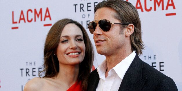Cast member Brad Pitt and actress Angelina Jolie pose at the premiere of