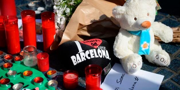 A picture taken on August 18, 2017 shows flowers, candles, messages, stuffed toys and others items displayed on the Rambla boulevard, to pay tribute to the victims of the Barcelona attack, a day after a van ploughed into the crowd, killing 13 persons and injuring over 100 on the Rambla in Barcelona.Drivers have ploughed on August 17, 2017 into pedestrians in two quick-succession, separate attacks in Barcelona and another popular Spanish seaside city, leaving 13 people dead and injuring more than 100 others. In the first incident, which was claimed by the Islamic State group, a white van sped into a street packed full of tourists in central Barcelona on Thursday afternoon, knocking people out of the way and killing 13 in a scene of chaos and horror. Some eight hours later in Cambrils, a city 120 kilometres south of Barcelona, an Audi A3 car rammed into pedestrians, injuring six civilians -- one of them critical -- and a police officer, authorities said. / AFP PHOTO / Josep LAGO (Photo credit should read JOSEP LAGO/AFP/Getty Images)