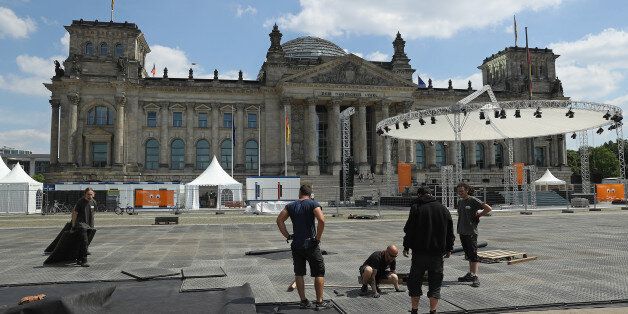 BERLIN, GERMANY - MAY 22: Workers in front of the Reichstag prepare the site for one of the opening church services ahead of the Protestant Church Congress on May 22, 2017 in Berlin, Germany. Up to 200,000 faithful are expected to attend the five-day congress in Berlin and Wittenberg that this year is celebrating the 500th anniversary of the Reformation. (Photo by Sean Gallup/Getty Images)