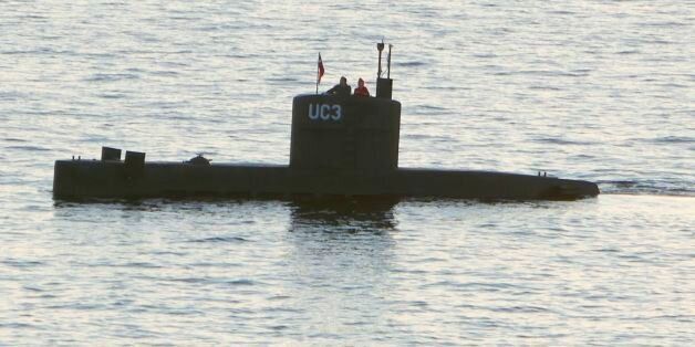 Allegedly Swedish journalist Kim Wall stands next to a man in the tower of the private submarine 'UC3 Nautilus' on August 10, 2017 in Copenhagen Harbor. Danish police said Sunday they searched a huge DIY submarine that sank last week in the hunt for the missing journalist who had been aboard before it sank, but no body was found. - / AFP PHOTO / Peter THOMPSON (Photo credit should read PETER THOMPSON/AFP/Getty Images)