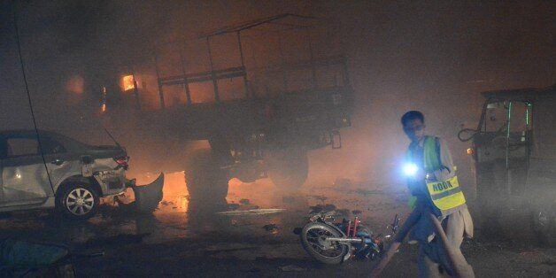 QUETTA,PAKISTAN-AUGUST 12: Fire fighters try to extinguigh a fire after powerful blast struck a military vehicle at a busy street in Quetta, the capital of southwestern Balochistan province, Pakistan on August 12, 2017. At least 15 people were killed and some 25 injured in an attack on an army vehicle in southwestern Pakistan on Saturday night, according to army officials and local media. (Photo by Mazhar Chandio/Anadolu Agency/Getty Images)
