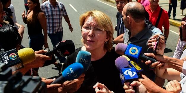 Venezuela's chief prosecutor Luisa Ortega (C), one of President Nicolas Maduro's most vocal critics, speaks to the press during a flash visit to the Public Prosecutor's office in Caracas on August 5, 2017 as national guard units are posted at the entries and exits to the building.Venezuela's dissident attorney general Ortega said Saturday her offices were 'under siege' by troops, as a new loyalist assembly was about to start work to bolster the policies of President Nicolas Maduro and counter his foes. / AFP PHOTO / Ronaldo SCHEMIDT (Photo credit should read RONALDO SCHEMIDT/AFP/Getty Images)