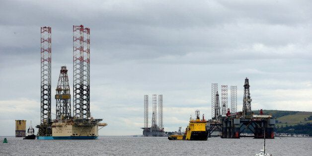 The Balder Viking offshore tug boat, center, tows the Maersk Reacher mobile offshore drilling unit, operated by Maersk Drilling Services AS, left, into the Port of Cromarty Firth in Cromarty, U.K., on Tuesday, July 26, 2016. The pace of North Sea oil-field shutdowns is picking up as the impact of the market slump is compounded by the uncertainvestment environment created by Brexit. Photographer: Matthew Lloyd/Bloomberg via Getty Images