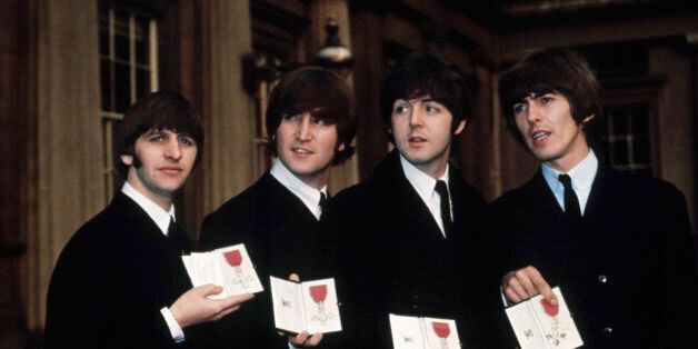 The Beatles (l to r) Ringo Starr, John Lennon, Paul McCartney, and George Harrison show off their MBE medals after their investiture at Buckingham Palace. (Photo by Â© Hulton-Deutsch Collection/CORBIS/Corbis via Getty Images)