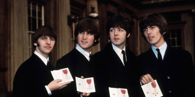 The Beatles (l to r) Ringo Starr, John Lennon, Paul McCartney, and George Harrison show off their MBE medals after their investiture at Buckingham Palace. (Photo by © Hulton-Deutsch Collection/CORBIS/Corbis via Getty Images)