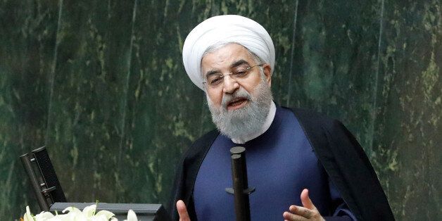 Iranian President Hassan Rouhani (C) delivers a speach to the parliament in Tehran on August 20, 2017, as Iran's parliament prepares to vote on the president's cabinet.Iran's President said the top foreign policy priority for his new government was to protect the nuclear deal from being torn up by the United States. / AFP PHOTO / STR (Photo credit should read STR/AFP/Getty Images)