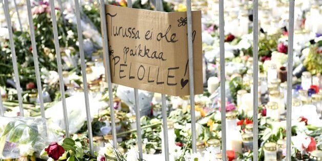 Candles, flowers and a placard reading 'There is no place for fear in Turku' have been left at the makeshift memorial for the victims of Friday's stabbings at the Turku Market Square, Finland on August 20, 2017.Ten people were stabbed in Central Turku on August 18, 2017 and two persons have been confirmed dead. / AFP PHOTO / Lehtikuva / Vesa Moilanen / Finland OUT (Photo credit should read VESA MOILANEN/AFP/Getty Images)