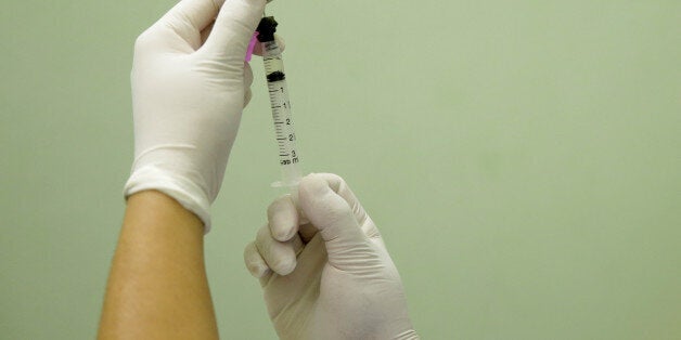 A health agent prepares a vaccine during a campaign of vaccination against yellow fever in Rio de Janeiro, Brazil, March 25, 2017. REUTERS/Ricardo Moraes