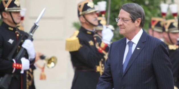 PARIS, FRANCE - SEPTEMBER 28: Greek Cypriot Leader Nikos Anastasiadis walks past honor guard during an official welcome ceremony prior to his meeting with French President Francois Hollande at the Elysee Presidential Palace in Paris, France on September 28, 2016. (Photo by Mustafa Sevgi/Anadolu Agency/Getty Images)