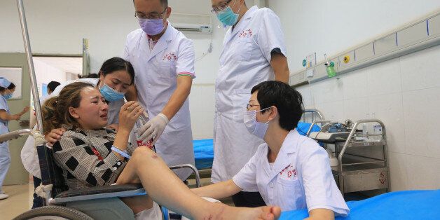 ABA, CHINA - AUGUST 09: Doctors comfort an injured woman after an earthquake at Jiuzhaigou County on August 9, 2017 in Tibetan and Qiang autonomous prefecture of Aba, Sichuan Province of China. A magnitude-7.0 earthquake struck Jiuzhaigou County at 9:19 pm on Tuesday. 19 were killed and 343 injured in the earthquake struck Sichuan. (Photo by VCG/VCG via Getty Images)