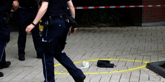 A police officer walks past crime scene after a knife attack in a supermarket in Hamburg, Germany, July 28, 2017. REUTERS/Morris Mac Matzen TPX IMAGES OF THE DAY