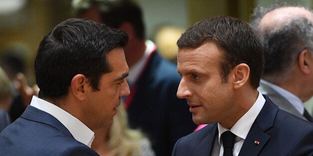 French President Emmanuel Macron (R) speaks with Greek Prime Minister Alexis Tsipras as he attends his first European Council in Brussels, on June 22, 2017. / AFP PHOTO / EMMANUEL DUNAND (Photo credit should read EMMANUEL DUNAND/AFP/Getty Images)