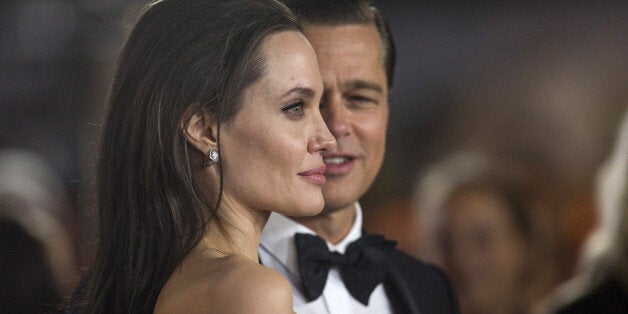 Director and cast member Angelina Jolie and her husband and co-star Brad Pitt pose at the premiere of