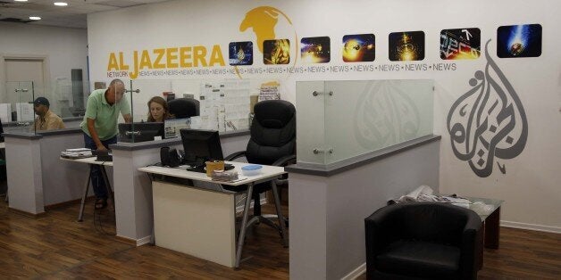 JERUSALEM - JULY 29: Employees of Qatar based news network and TV channel Al-Jazeera are seen on their duty at the Jerusalem office where on July 29, 2017. Prime Minister Benjamin Netanyahu plans to shut down the Jerusalem office of the Al-Jazeera's news network with an unfair accusation of it promotes violence over Temple Mount. (Photo by Mahmoud Ibrahem/Anadolu Agency/Getty Images)