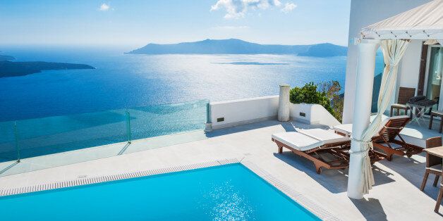 White architecture on Santorini island, Greece. Swimming pool in luxury hotel. Beautiful landscape with sea view