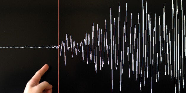 A technician of the French National Seism Survey Institute (RENASS) presents a graph on March 11, 2011 in Strasbourg, Eastern France, registered today during a major earthquake in Japan. A 8.9 magnitude quake hit northeast Japan today, causing many injuries, deaths, fires and a tsunami along parts of the country's coastline. AFP PHOTO / FREDERICK FLORIN (Photo credit should read FREDERICK FLORIN/AFP/Getty Images)